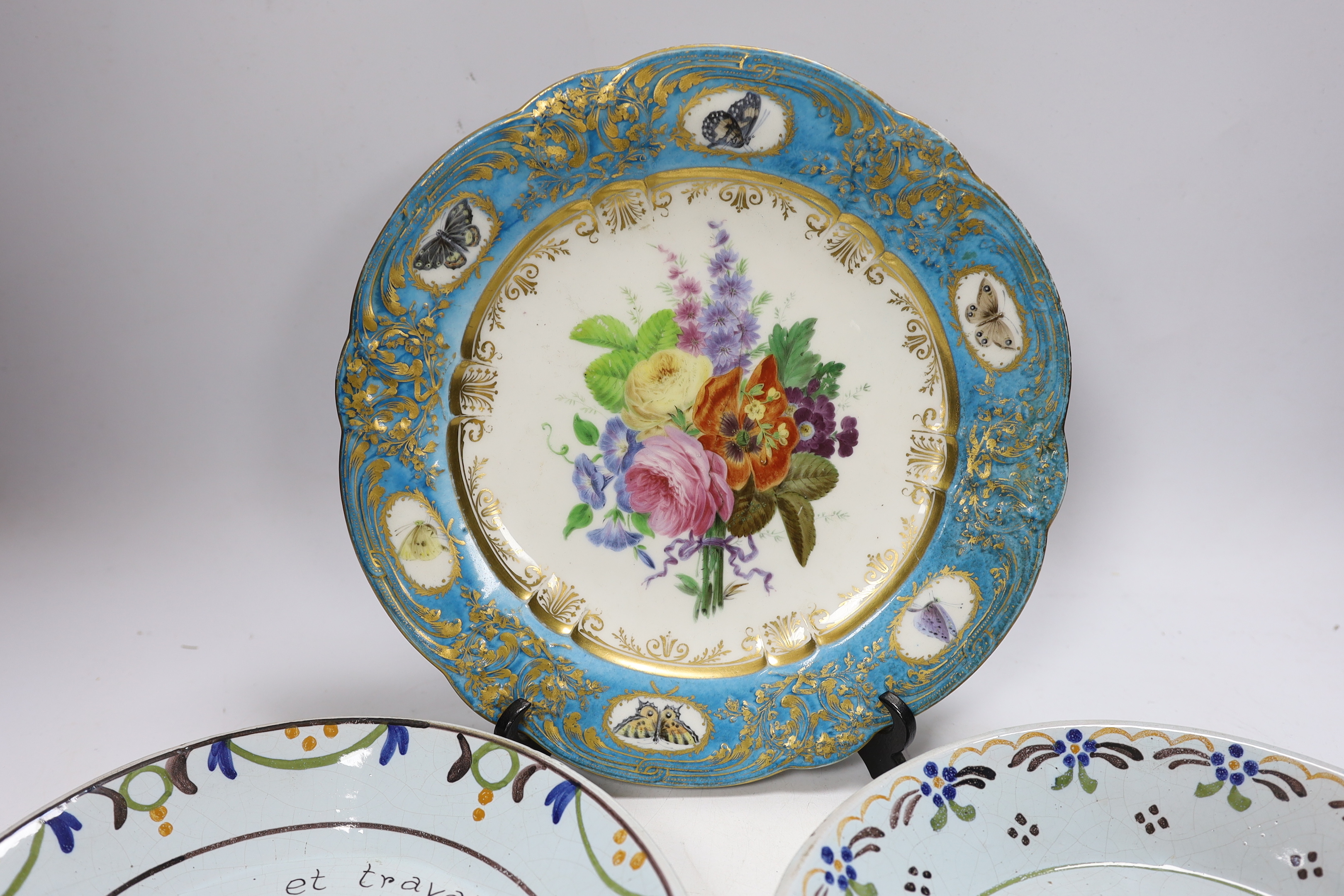 A pair of French revolution commemorative faience dishes and an 18th century Sevres plate, with later decoration, largest 23cm in diameter